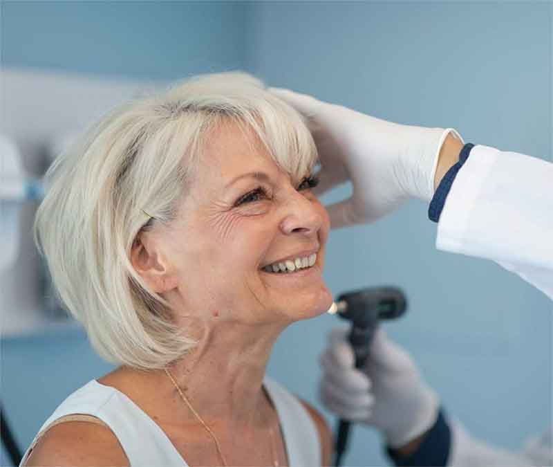 TheWebDoctor Woman having her ears examined by a hearing expert